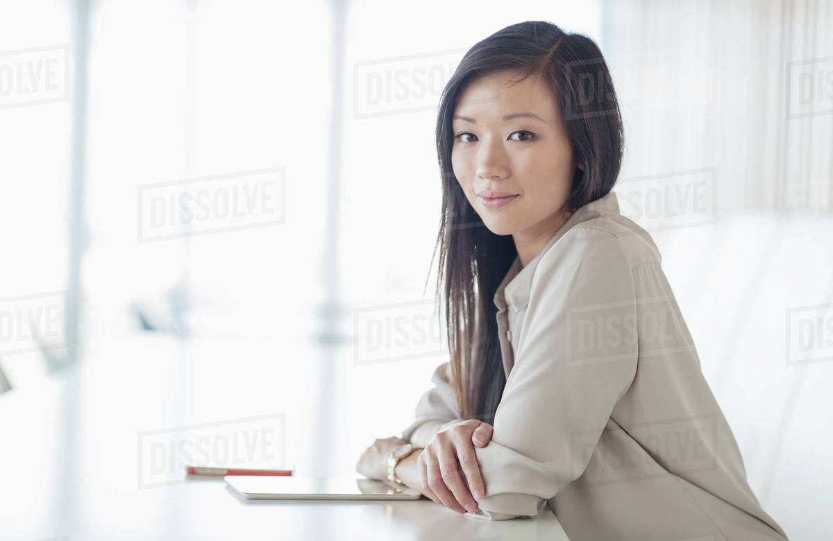 Portrait smiling businesswoman with digital tablet in conference room Royalty-free stock photo