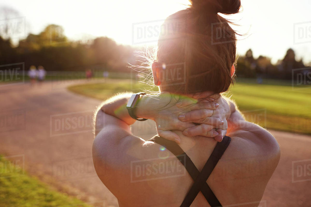 Young Woman Wearing Activity Tracker Stretches Before Run Royalty-free stock photo