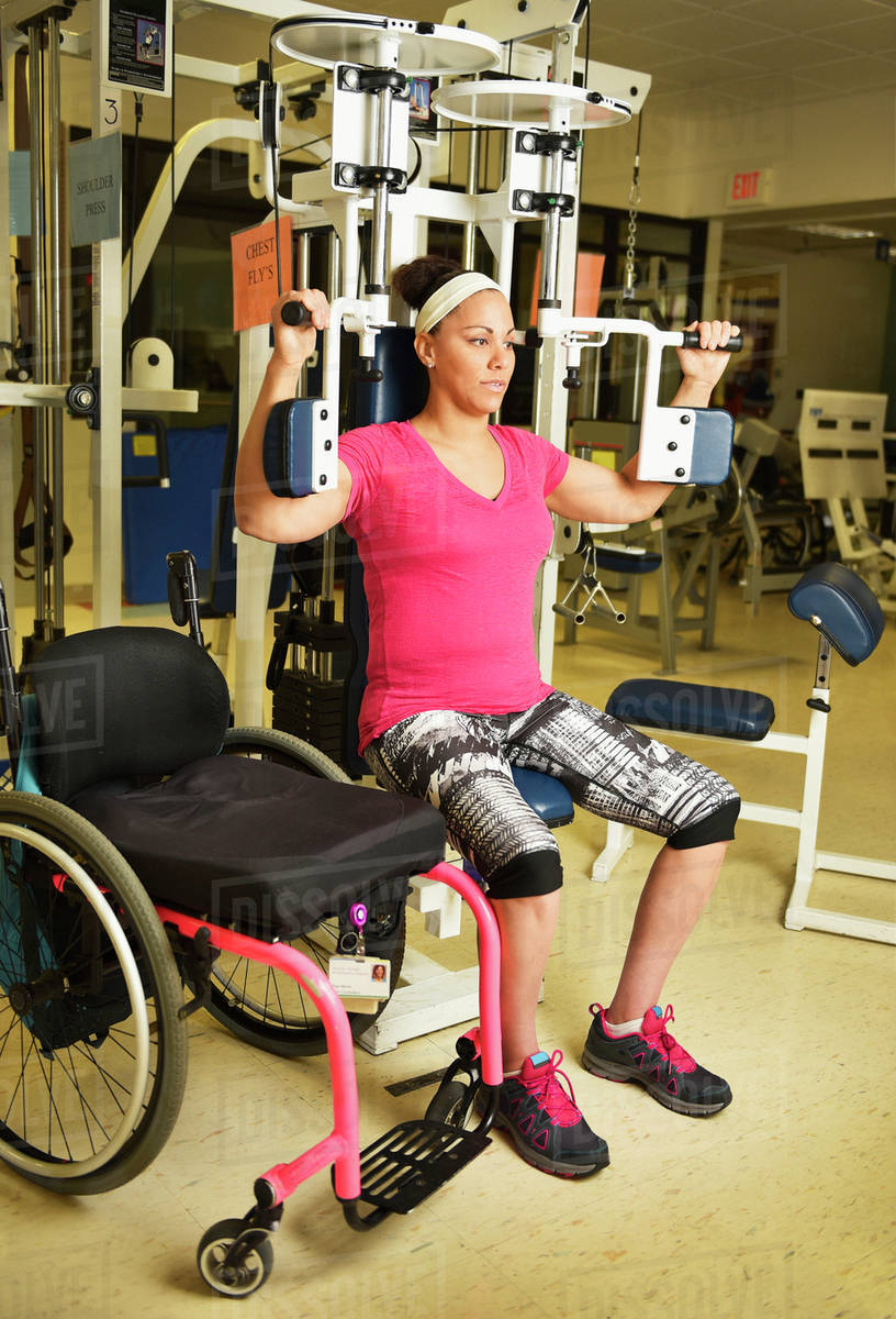 Paraplegic woman working out in physical therapy Stock Photo Dissolve