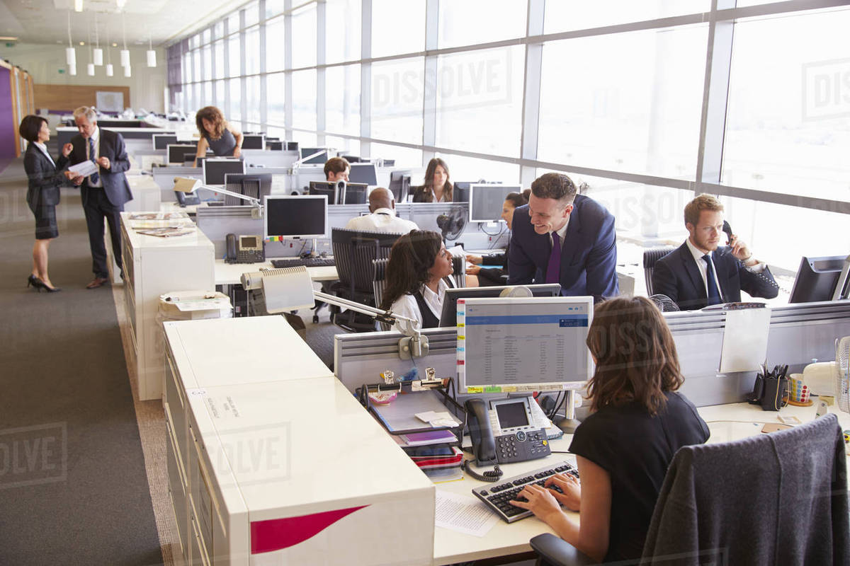 Manager in discussion with coworker in an open plan office Royalty-free stock photo
