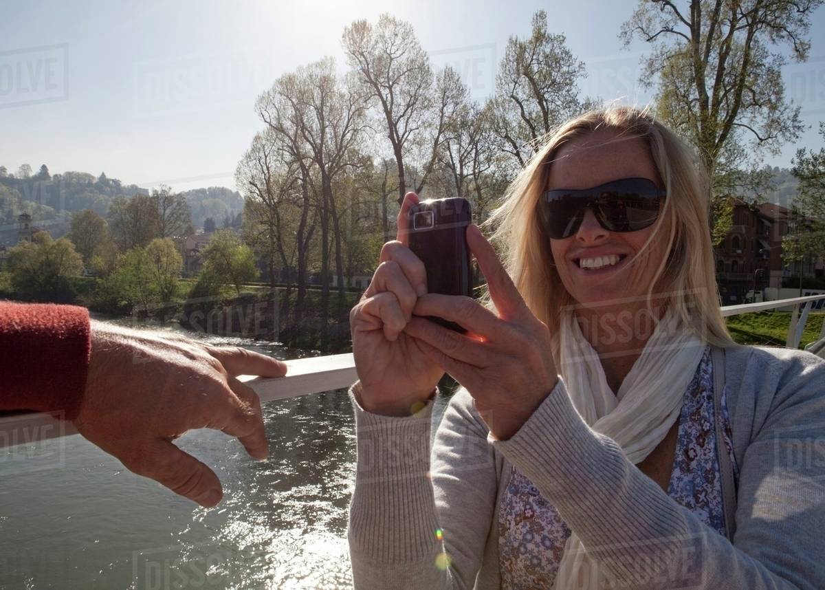 Woman taking pictures with her smartphone Royalty-free stock photo