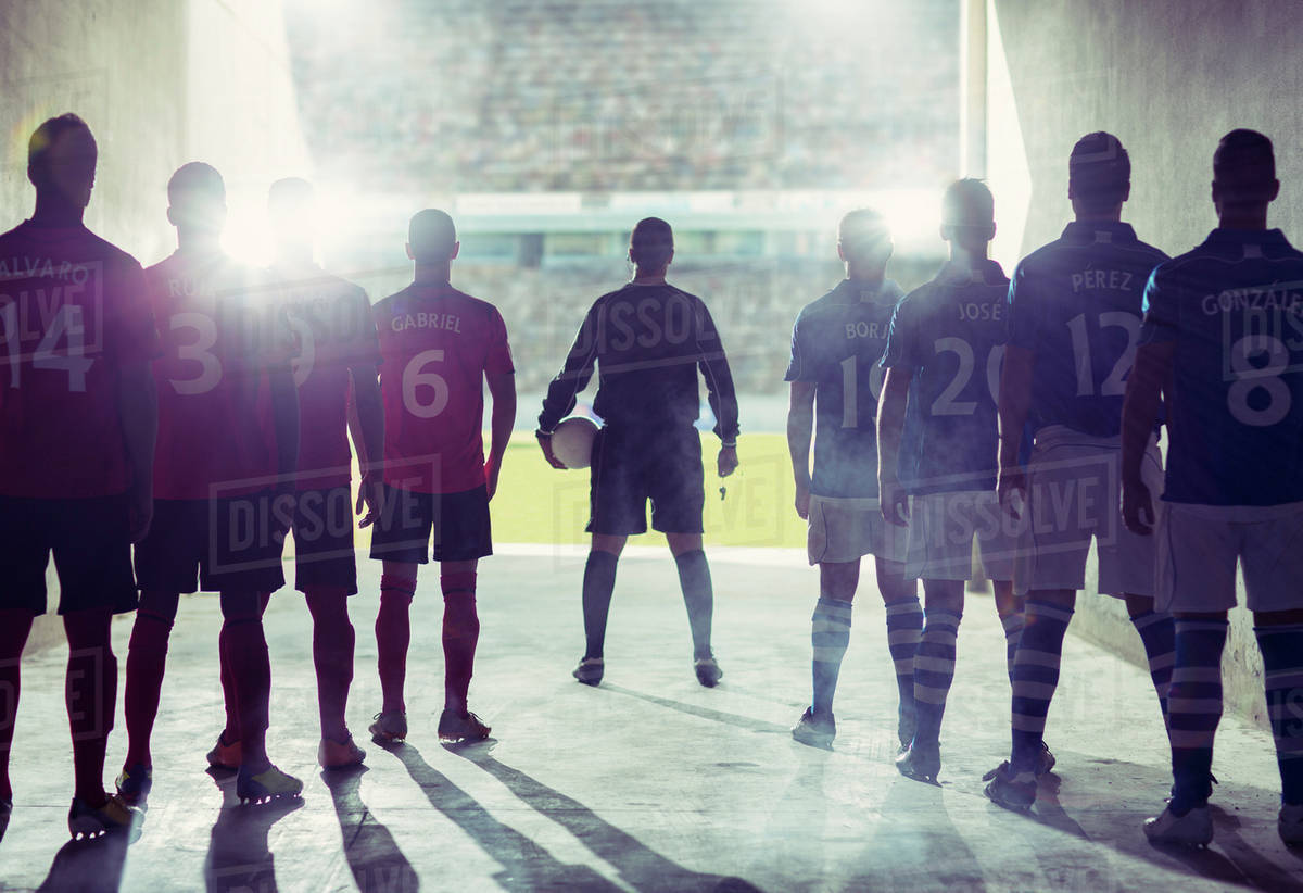 silhouette of soccer teams facing field