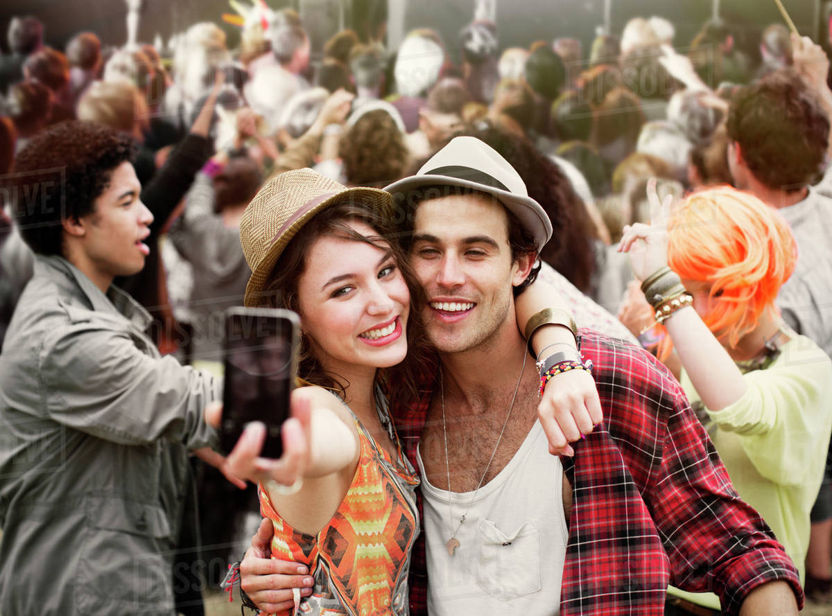 Couple taking self-portrait at music festival Royalty-free stock photo