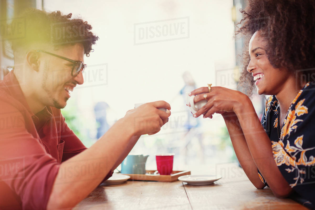 Couple drinking coffee face to face in cafe Royalty-free stock photo