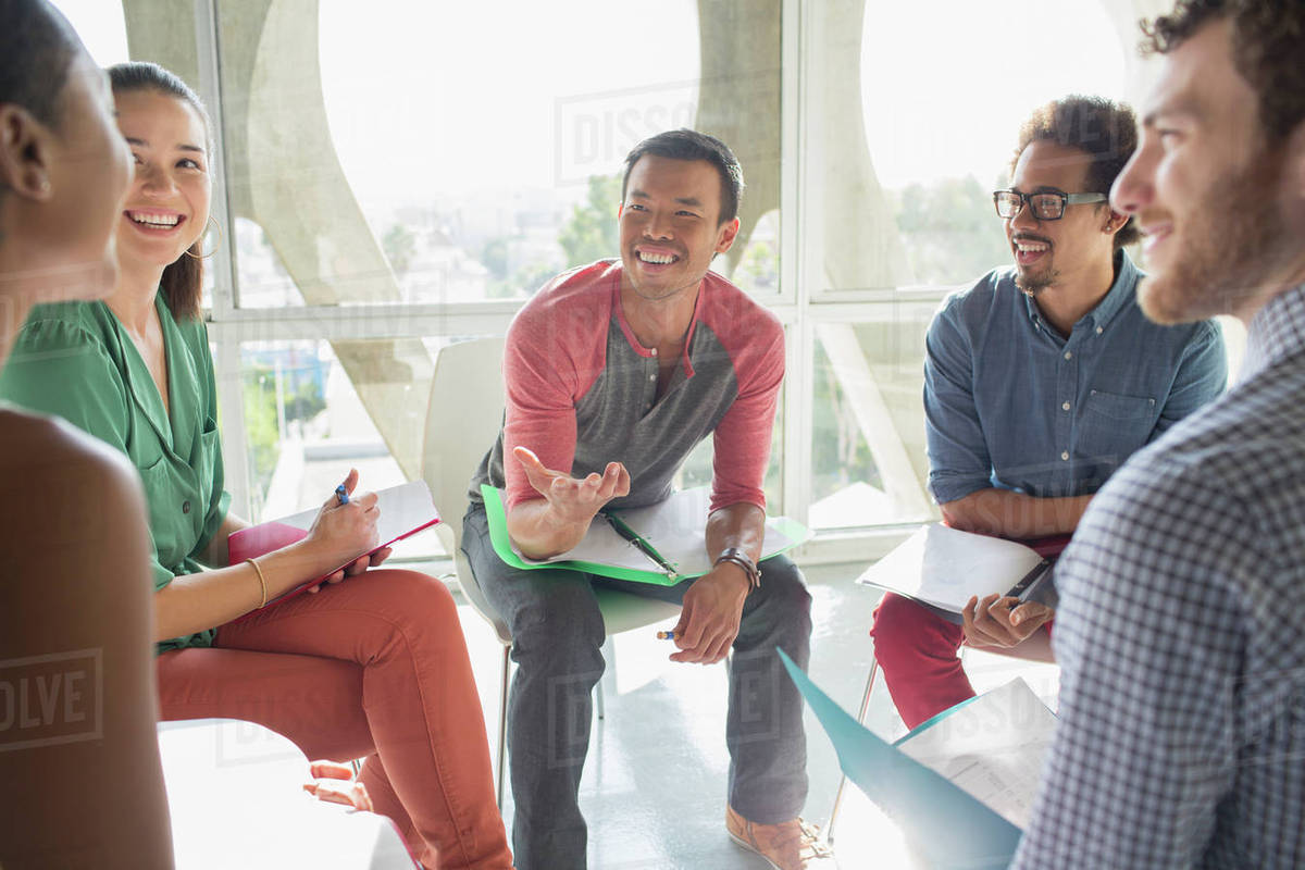 Creative business people meeting in circle of chairs Royalty-free stock photo
